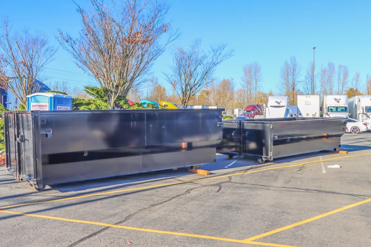 Professional dumpster rental service with roll-off container on residential driveway in Hanford